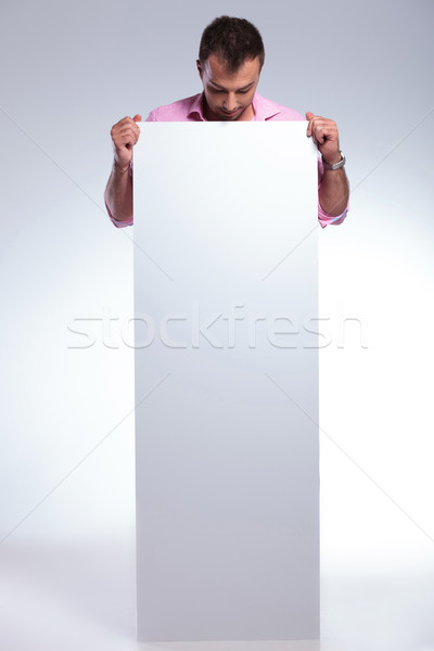 casual man holds pannel with both hands Stock photo © feedough