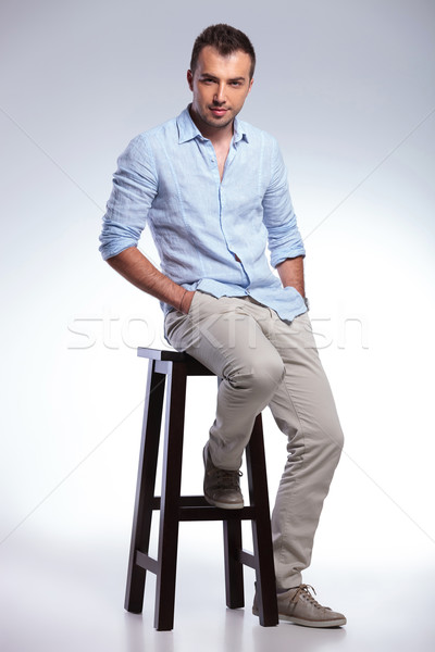 seated casual man with both hands in pockets Stock photo © feedough