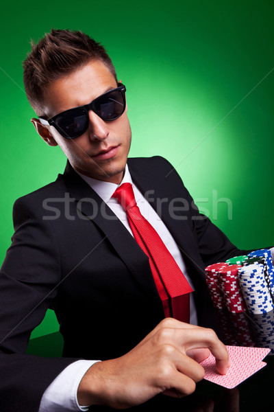 Stock photo: Business man playing with poker face  