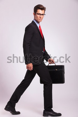 business man walks with suitcase in hand Stock photo © feedough