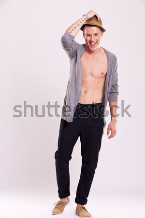 cute man holding hat and smiling Stock photo © feedough