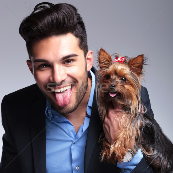 casual young man holds puppy and pants Stock photo © feedough