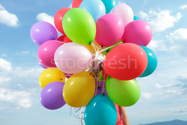 bunch of balloons held by a man outdoor Stock photo © feedough
