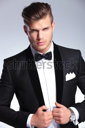 imposing fashion man in tuxedo snapping his fingers Stock photo © feedough