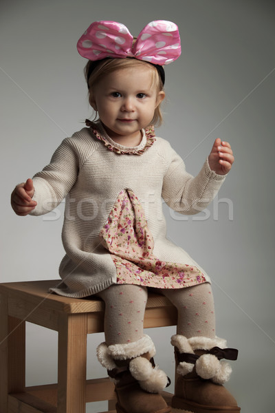 seated little beautiful girl wearing a pink bow headband  Stock photo © feedough