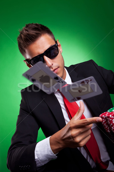 Young business man throwing a pair of aces Stock photo © feedough