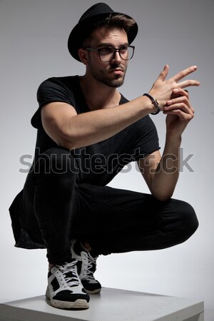 seated young man adjusting his sunglasses Stock photo © feedough
