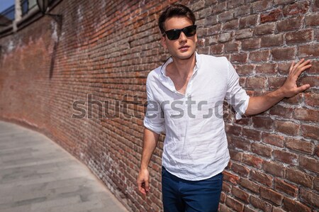 casual man holding his hand on head fixing his hair  Stock photo © feedough