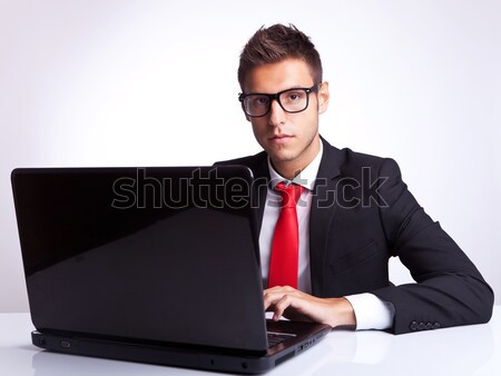 side of young business man at laptop, pointing at you Stock photo © feedough