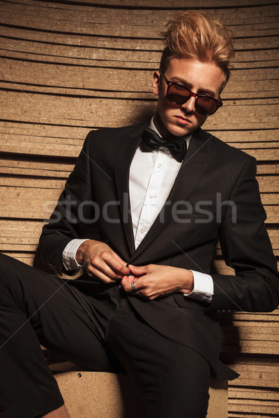 Blond young business man closing his jacket  Stock photo © feedough