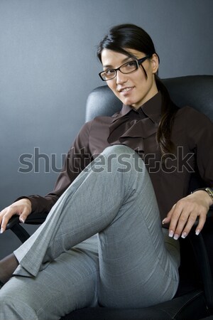 business man closing his jacket while sitting. Stock photo © feedough