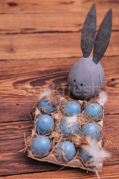 grey easter egg with bunny ears near blue eggs Stock photo © feedough