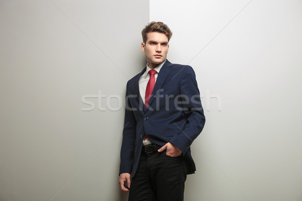 Pensive young business man holding one hand in his pocket Stock photo © feedough