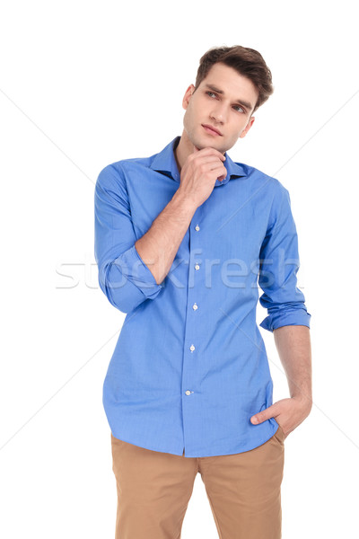 Nachdenklich junger Mann halten Hand Kinn nachschlagen Stock foto © feedough