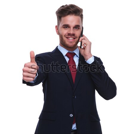 smiling businessman talks on the phone and makes ok sign Stock photo © feedough