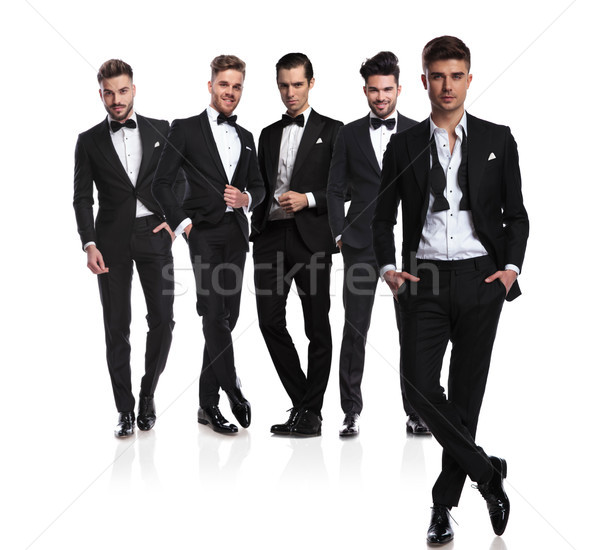 five groomsmen with leader with undone collar in front Stock photo © feedough