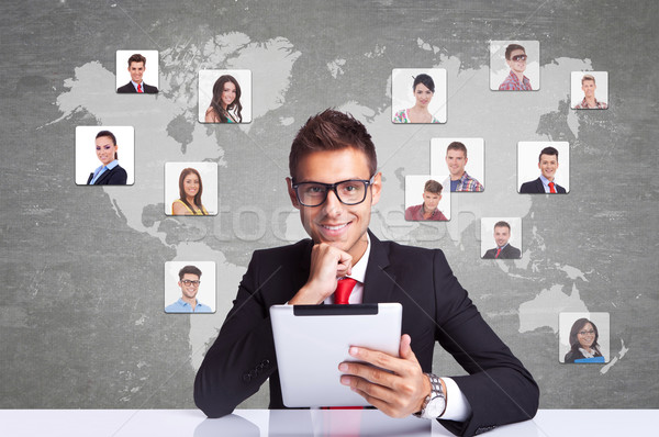 smiling business man with tablet pad networking Stock photo © feedough