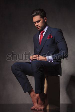 seated young business man taking his jacket off Stock photo © feedough