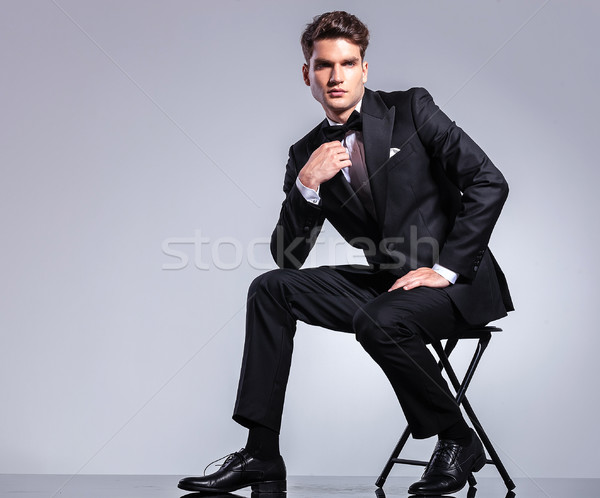 Handsome young business man fixing his bowtie Stock photo © feedough