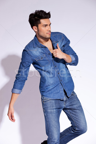 young man holding his blue shirt by the collar Stock photo © feedough