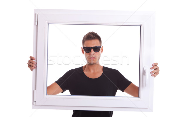 Férfi visel napszemüveg tart pvc ablakkeret Stock fotó © feedough