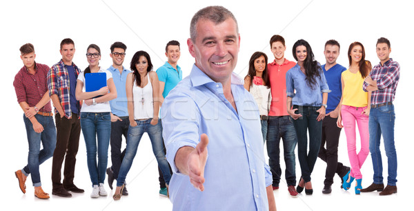 old casual man welcomes you with a handshake to his team Stock photo © feedough