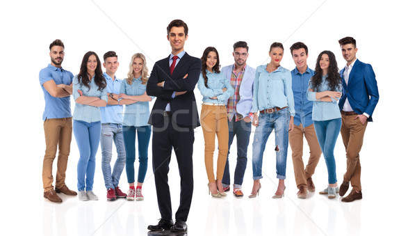 confident group leader standing while his team is behind him Stock photo © feedough