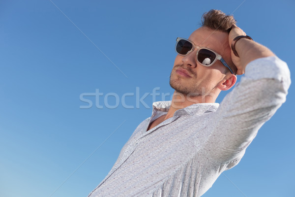 casual man passes hand through hair outdoor Stock photo © feedough