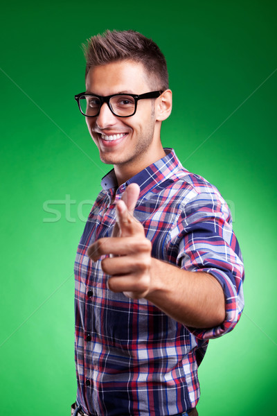 Stock photo: a casual young man pointing at the camera