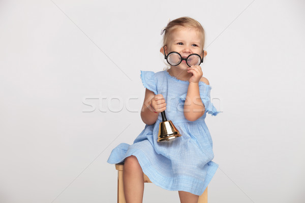 laughing little girl takes off her glasses and holds handbell  Stock photo © feedough