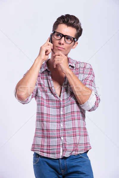 Stock photo: casual man thinks while on the phone