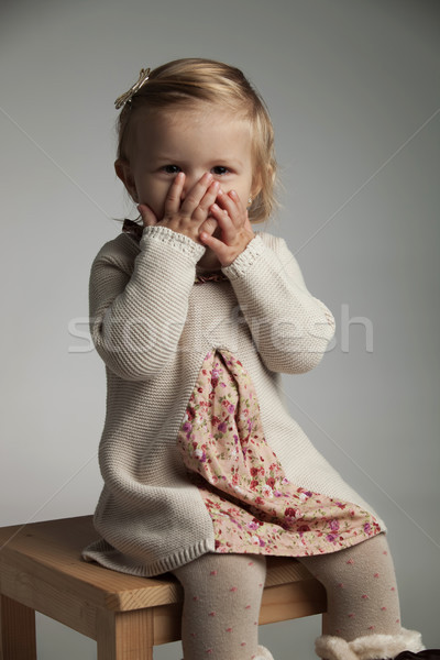 excited little girl covering her mouth with palms  Stock photo © feedough