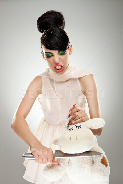 woman cutting the neck of her teddy bear  Stock photo © feedough