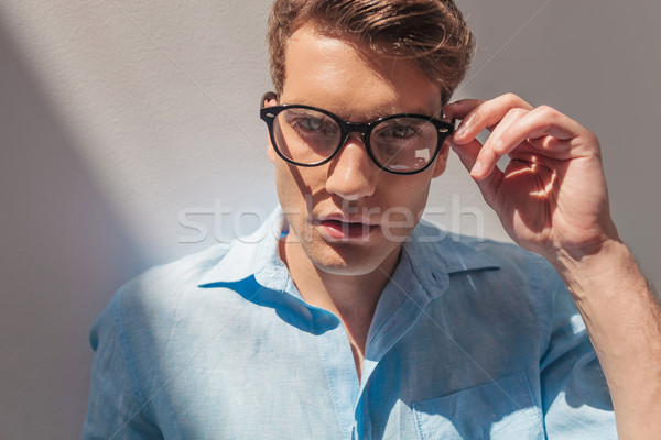 handsome casual man taking off his glasses. Stock photo © feedough