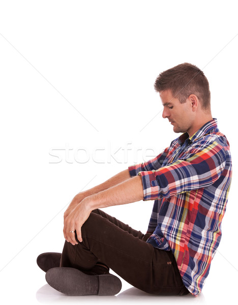 Stock photo: young man sitting looking down