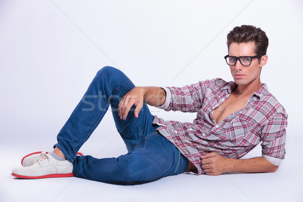 Casual man poses with thumbs in pockets on gray - Stock Image - Everypixel
