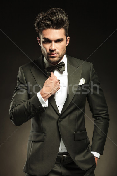 Handsome young business man fixing his bowtie  Stock photo © feedough