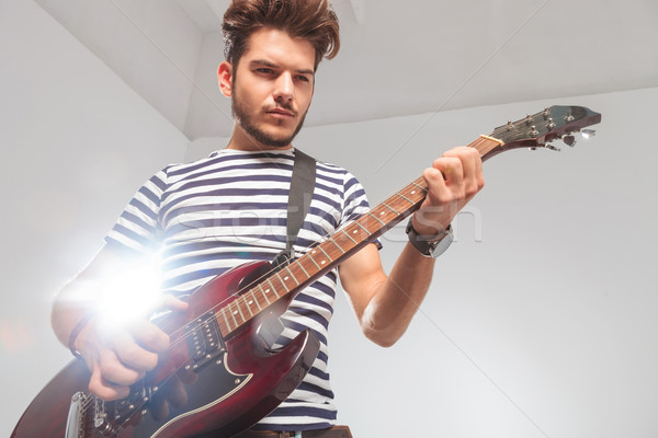 Rocker póz lefelé néz játszik elektromos gitár portré Stock fotó © feedough
