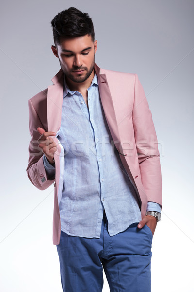 casual man with hand on lapel looks down Stock photo © feedough