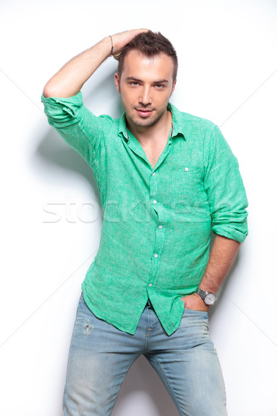 casual man poses with hand on head and in pocket Stock photo © feedough