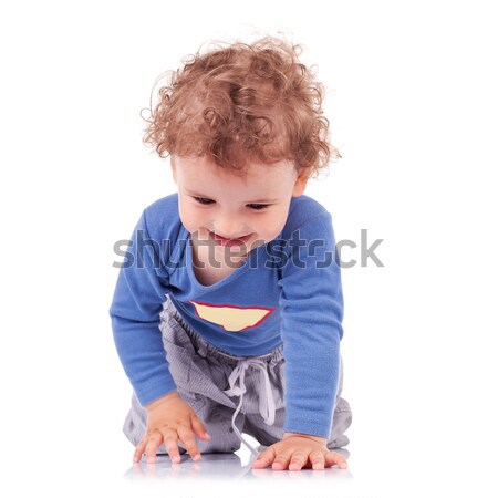 Curly-haired little boy crawling happily Stock photo © feedough