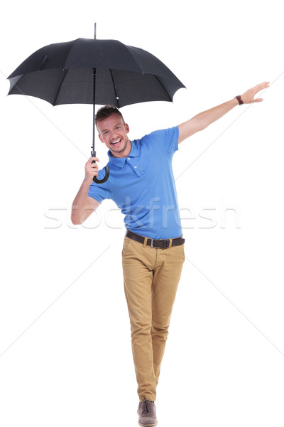 casual young man balancing with umbrella Stock photo © feedough