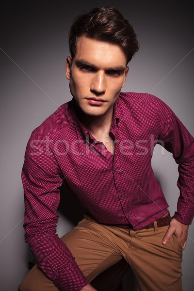 Young handsome casual man sitting on a stool Stock photo © feedough