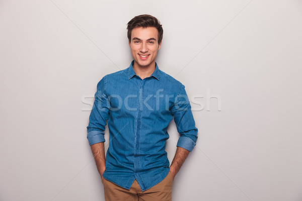 happy casual man with hands in pockets smiling Stock photo © feedough