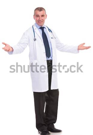full body picture of an old doctor welcoming you Stock photo © feedough