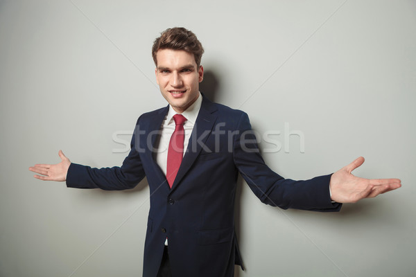 Happy young business man welcoming you Stock photo © feedough