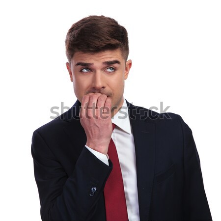 stressed businessman biting his nails looks up to side Stock photo © feedough
