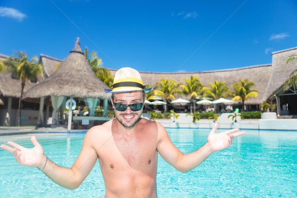 smiling young man  welcoming you to the pool Stock photo © feedough
