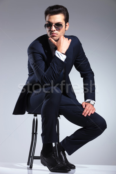 young elegant business man sitting on a stool Stock photo © feedough