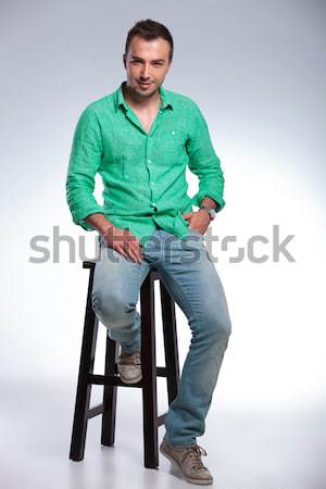 young man posing in studio background while climbing on a ladder Stock photo © feedough